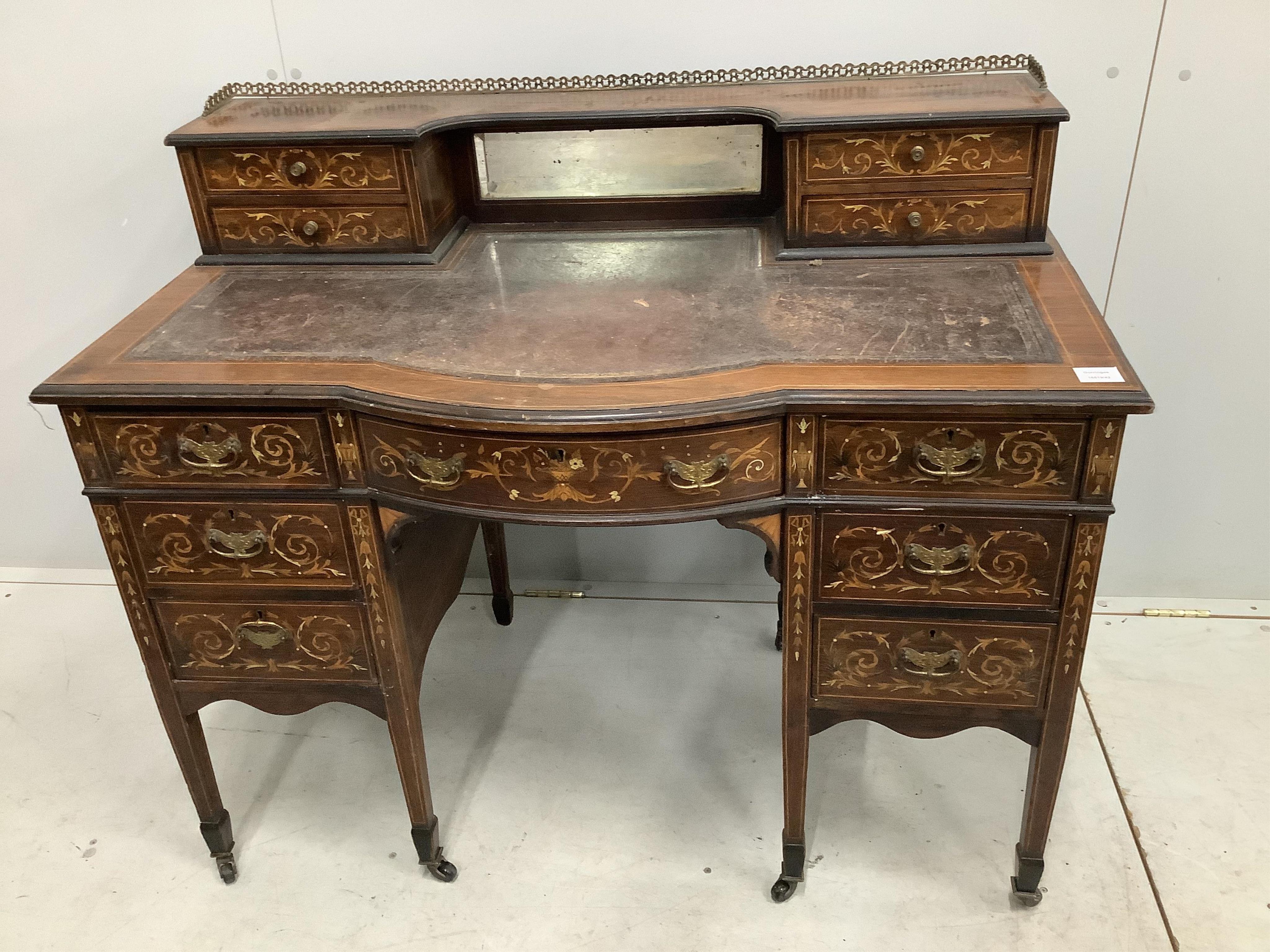 An Edwardian marquetry inlaid rosewood bowfront kneehole desk in the manner of Edwards and Roberts, width 110cm, depth 62cm, height 95cm. Condition - poor to fair